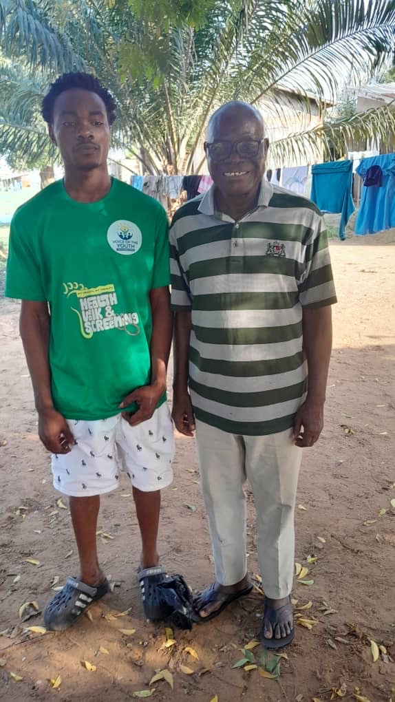 A former Emperor Academy student who returned years later to thank the school, standing with Dr. Anthony Akunzule