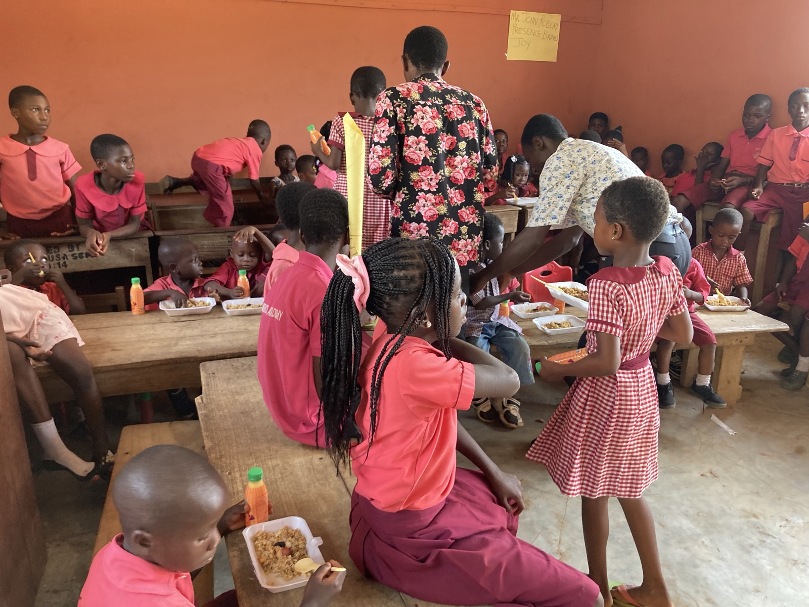 Emperor Academy children eating a warm meal together at school